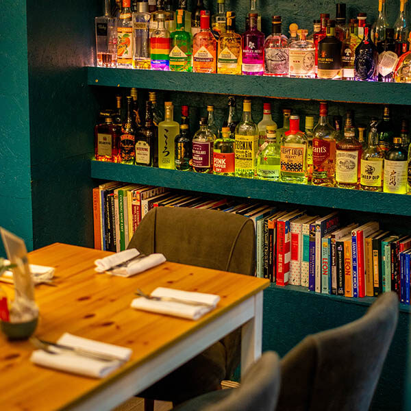 Interior view of alcohol stock and seating area inside Café Nucleus Chatham