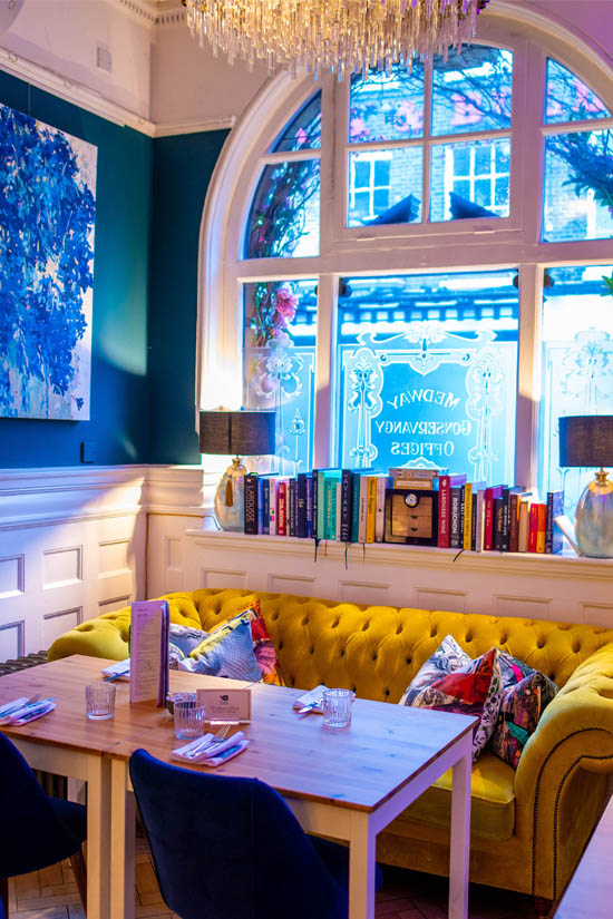Interior view of the yellow Chesterfield sofa at Café Nucleus Rochester