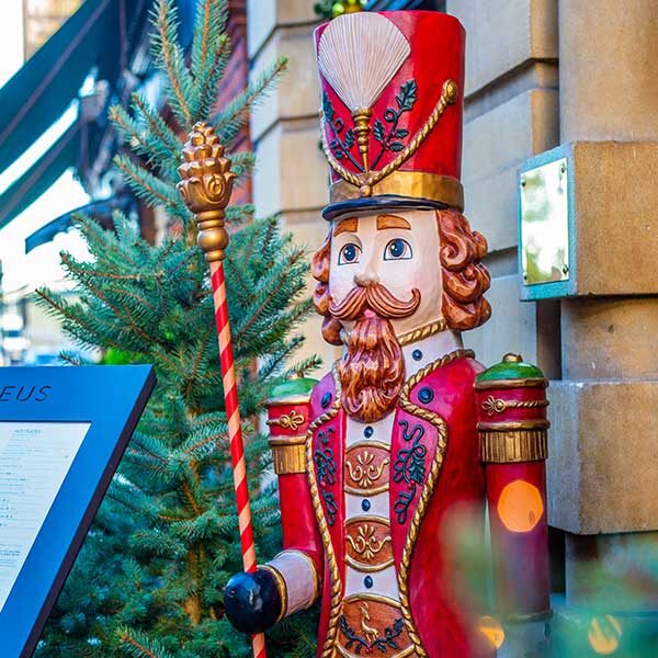 View of a large colourful nutcracker at the entrance to Café Nucleus Rochester.