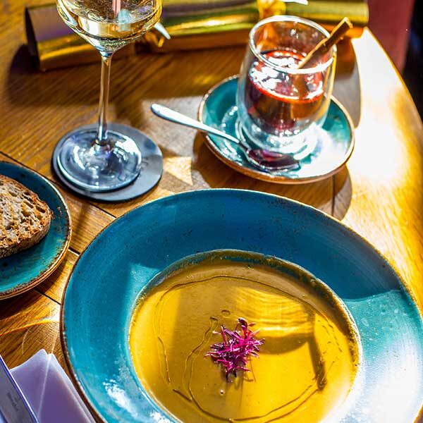 Close up of soup serve with a toast, a glass of champagne and festive drink